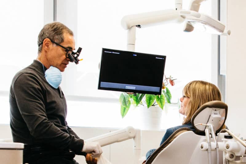 A PoloPark Dental Dentist answering a patient's question