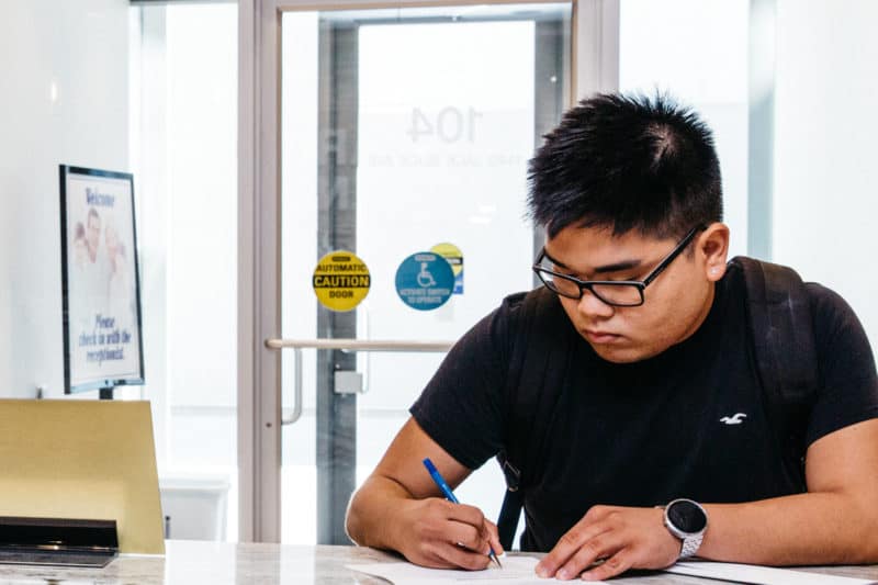 young man filling our paperwork